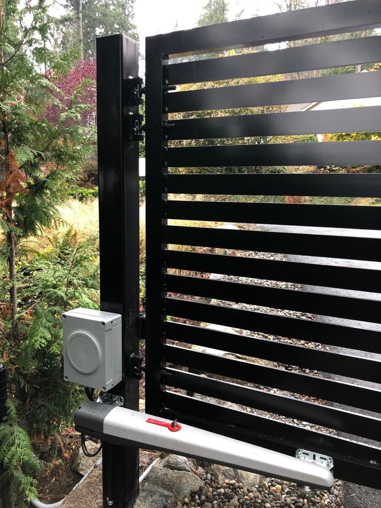 Close-up of a swing gate operator on a horizontal-slat gate